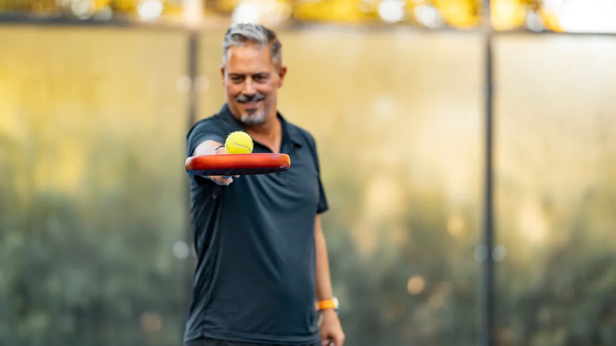 A padel ball balanced on Julian’s racket