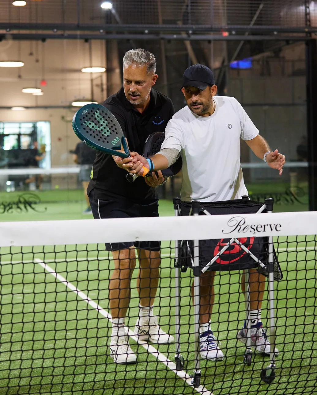Julian Wortelboer demonstrating padel technique with a player